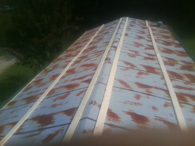Rusted metal roof panels with new wood purlins before replacement — Storm Damage Roof Repair in High Falls by Roofing Brothers