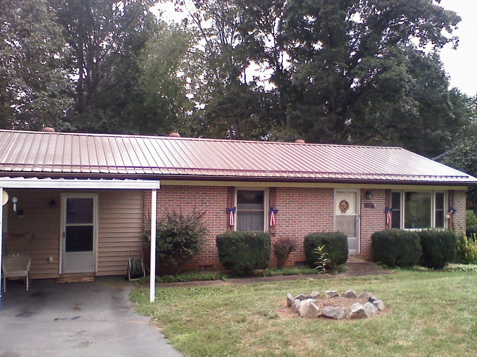 Bronze metal roof and carport on a brick ranch home — Roof Repair work by our crew in High Falls