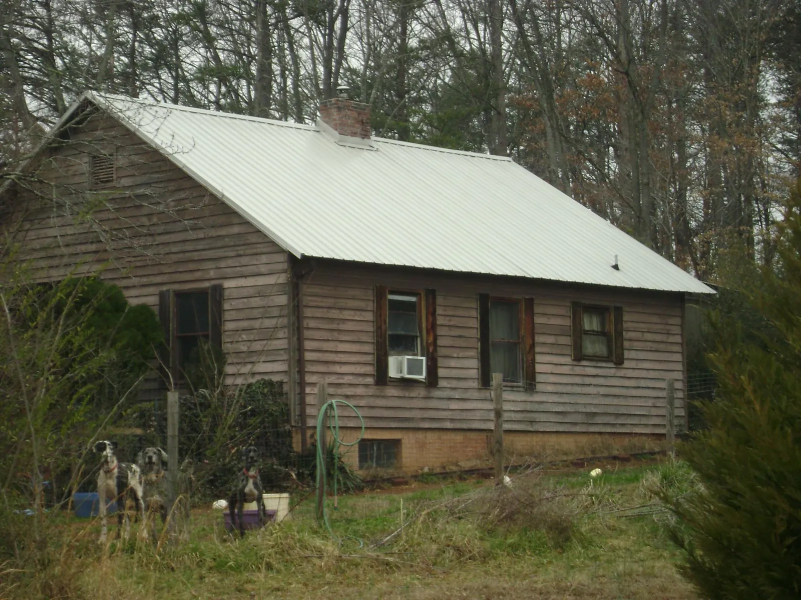 White metal roof on an old wood sided farmhouse, from a Metal Roof Installation job in High Falls